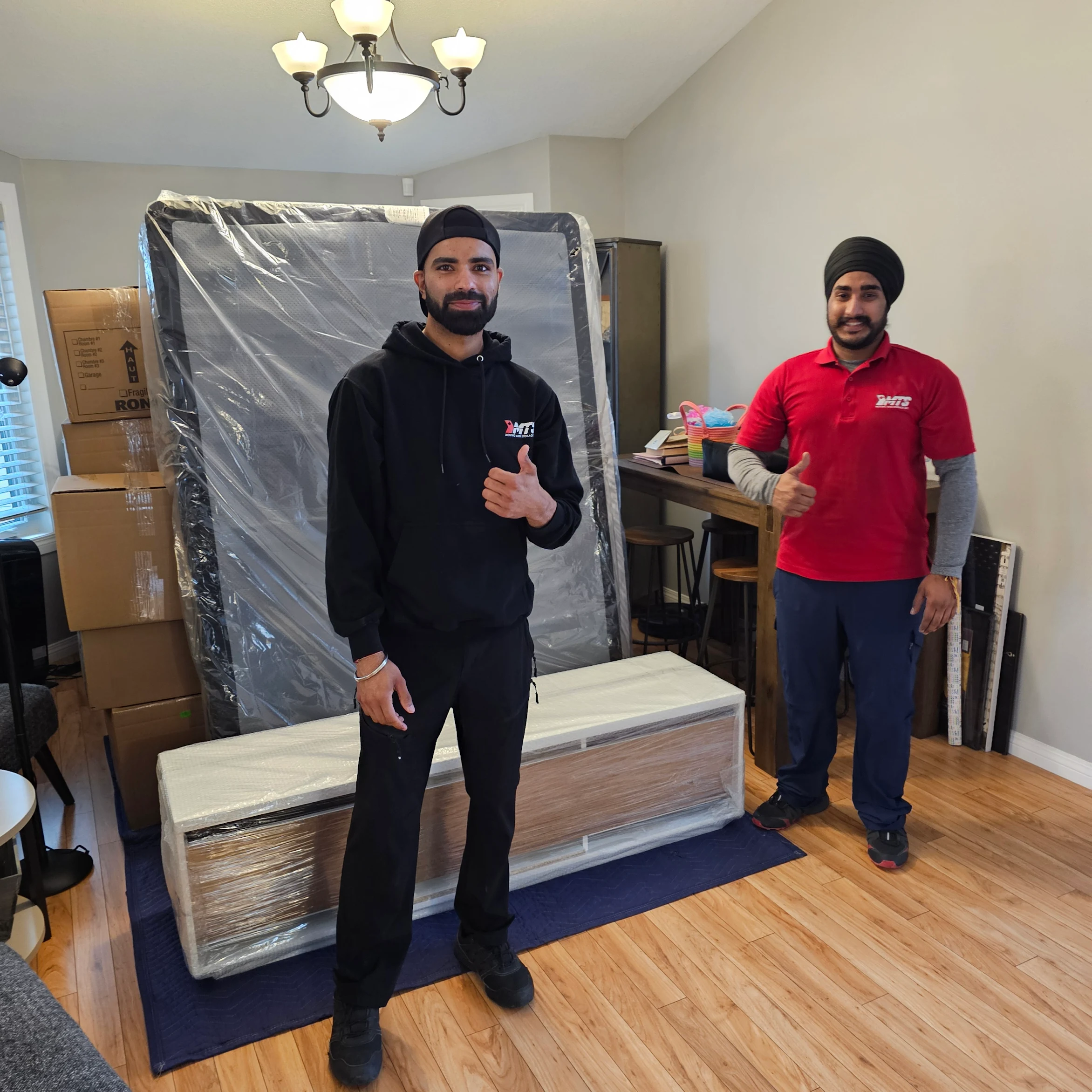 Shrink‑wrapping my mattress before the haul to Edmonton.